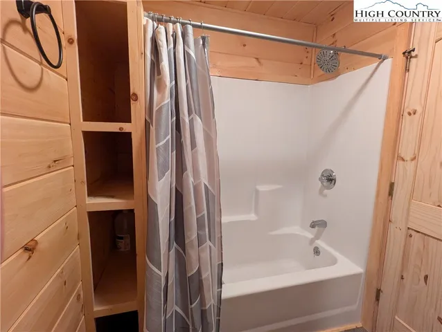 a bathroom with a bathtub and a shower