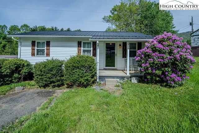 a front view of a house with a yard and porch