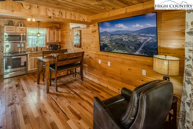 a room with furniture pool table and wooden floor