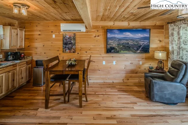 a view of a dining room with furniture wooden floor and a rug