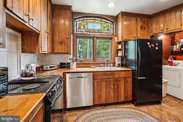 a kitchen with a refrigerator and a sink