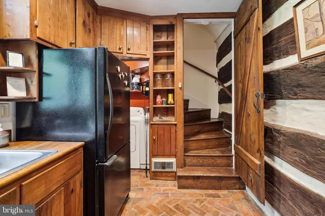 a kitchen with stainless steel appliances refrigerator and cabinets