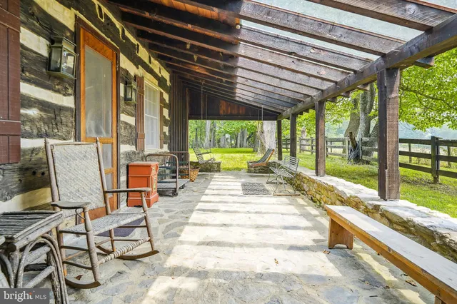 a swimming pool with outdoor seating and yard