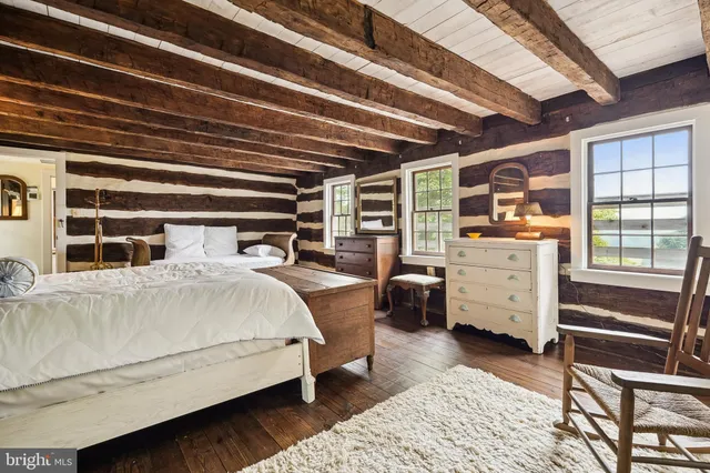 a bedroom with a bed wooden floor and a window