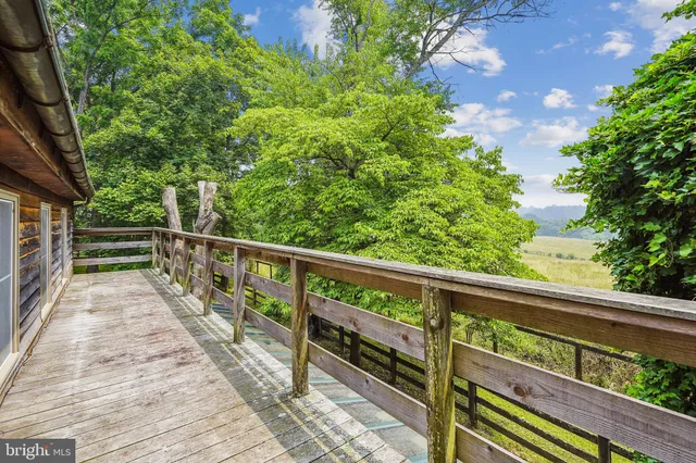 a view of balcony with wooden floor and fence