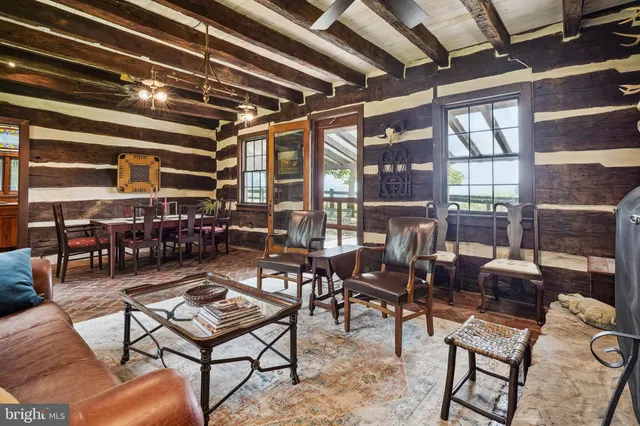 a living room with lots of furniture and a painting on the wall
