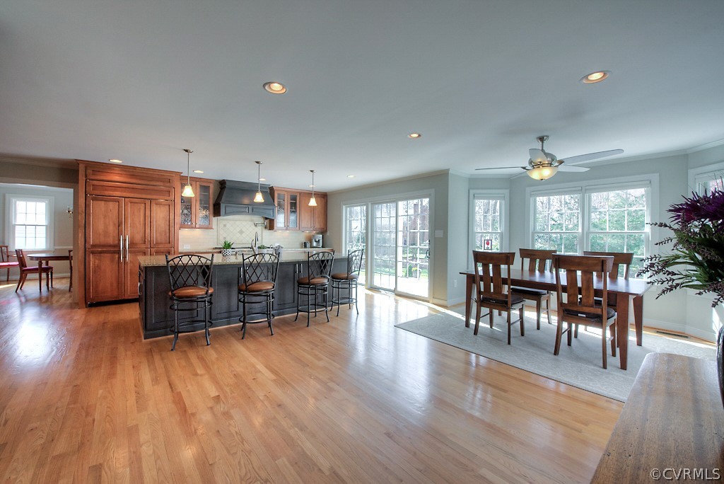 2252 Banstead Road Midlothian, VA 23113 - Photo 20 of 50 a kitchen with stainless steel appliances wooden floors dining table and chairs