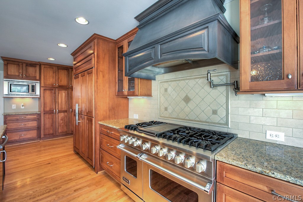 2252 Banstead Road Midlothian, VA 23113 - Photo 25 of 50 a kitchen with granite countertop a stove and a wooden cabinets