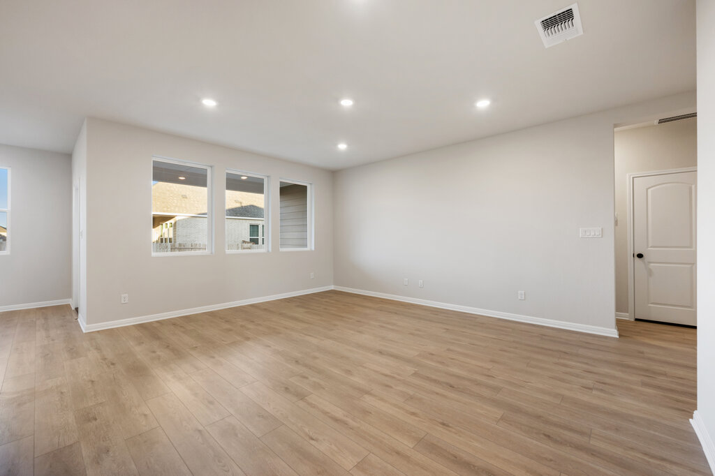 2509 Walking Y Road Georgetown, TX 78633 - Photo 16 of 40 an empty room with wooden floor and windows