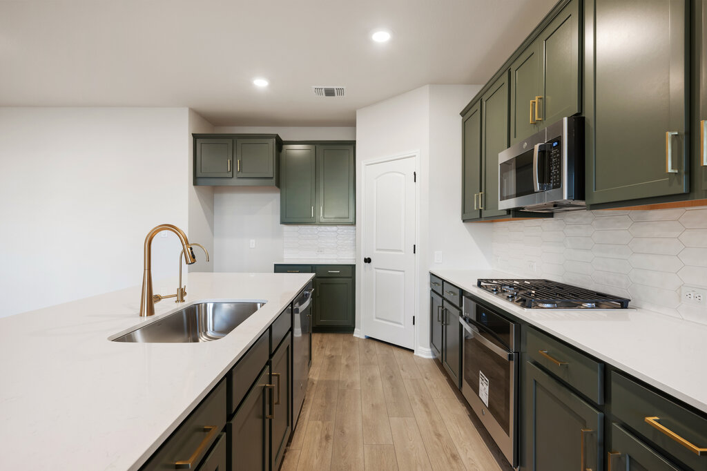 2509 Walking Y Road Georgetown, TX 78633 - Photo 22 of 40 a kitchen that has a sink and a stove