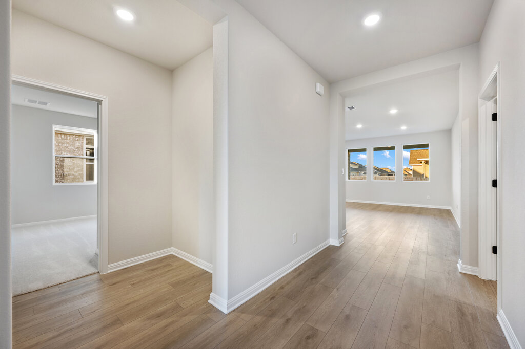 2509 Walking Y Road Georgetown, TX 78633 - Photo 7 of 40 an empty room with wooden floor and windows