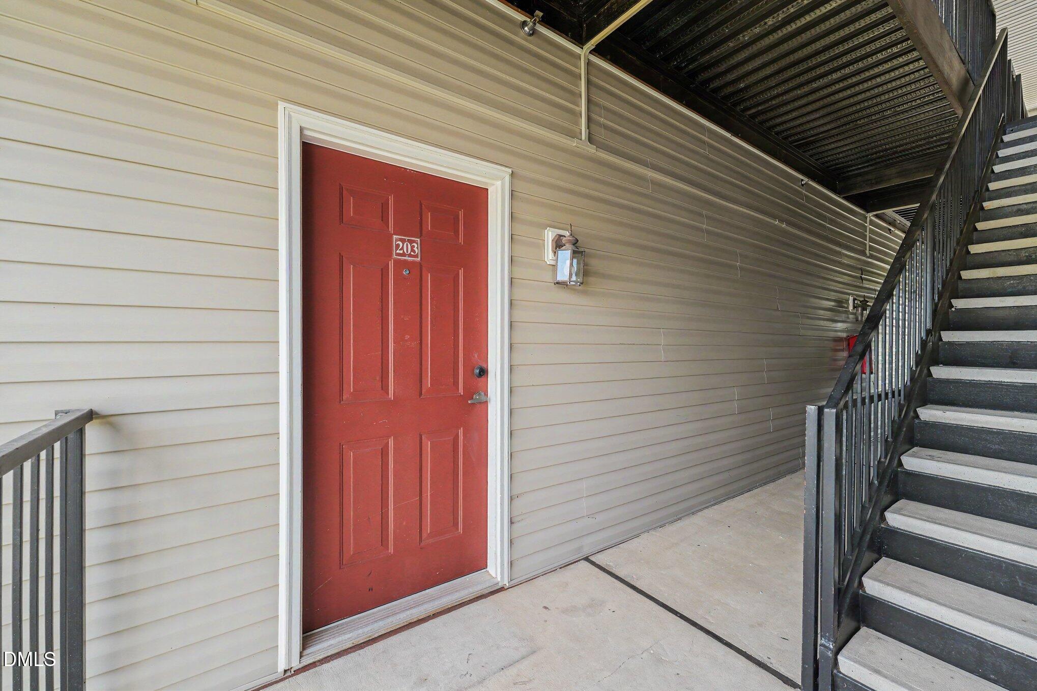 2521 Friedland Place Raleigh, NC 27617 - Photo 17 of 21 Covered, breezeway-style entry porch with exterior lighting, protecting your doorway from the elements and offering a secure, low-maintenance arrival space.