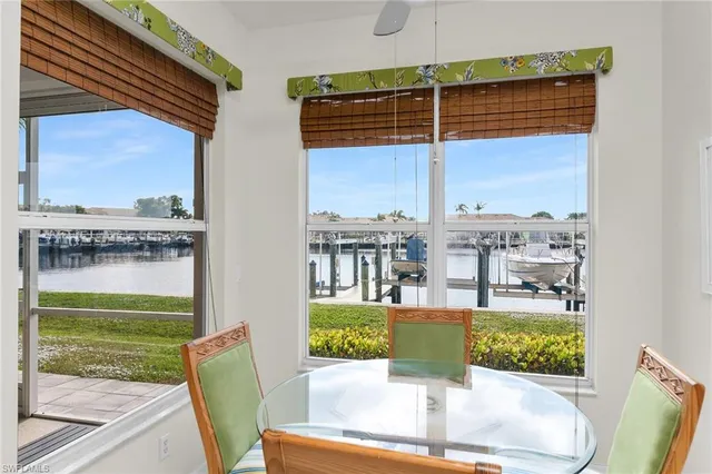 a living room with stainless steel appliances granite countertop furniture and a couch