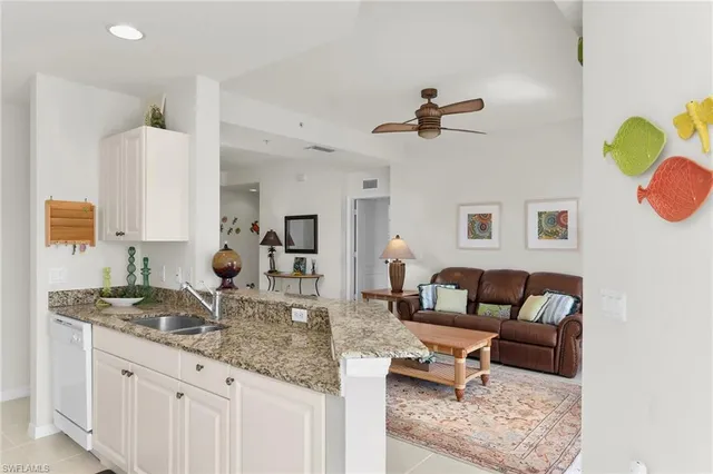 a living room with furniture a rug and a window