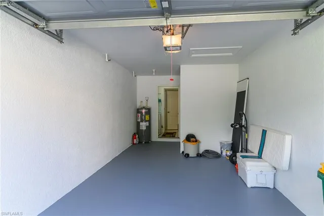 a swimming pool that has lawn chairs and a dining table with garden view