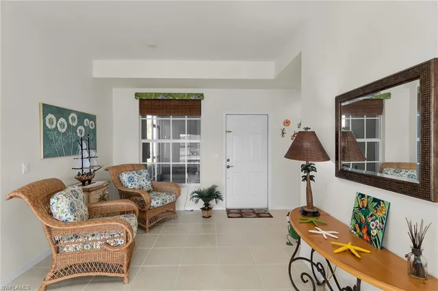 a living room with furniture a rug and a large window