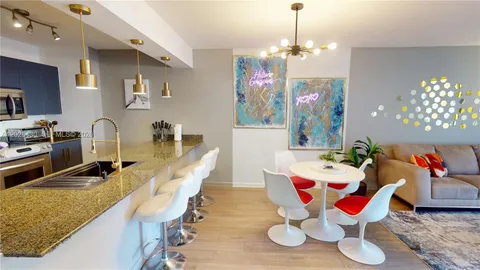 a dining room with wooden floor a chandelier a wooden table and chairs
