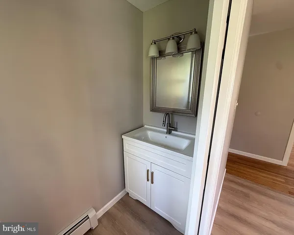 a white toilet sitting in a bathroom next to a window