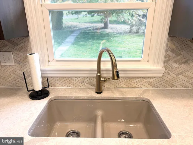 a kitchen with granite countertop cabinets stainless steel appliances and a counter space