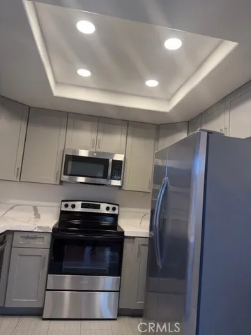 a kitchen with granite countertop a refrigerator and a stove