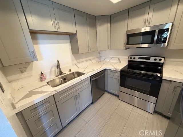 a kitchen with a sink stove and microwave