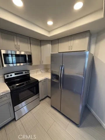 a kitchen with a refrigerator and a stove