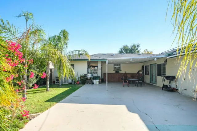a view of a house with a yard and sitting area