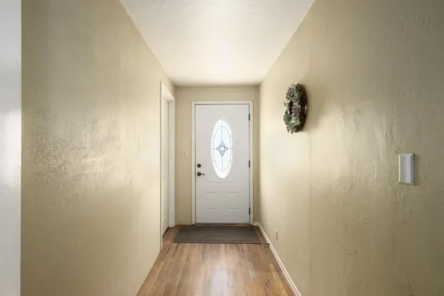 a view of bathroom with a sink and wooden floor