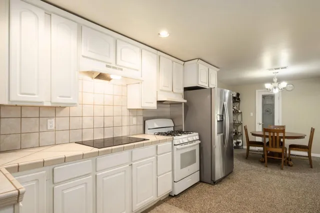 a kitchen with refrigerator cabinets and a sink