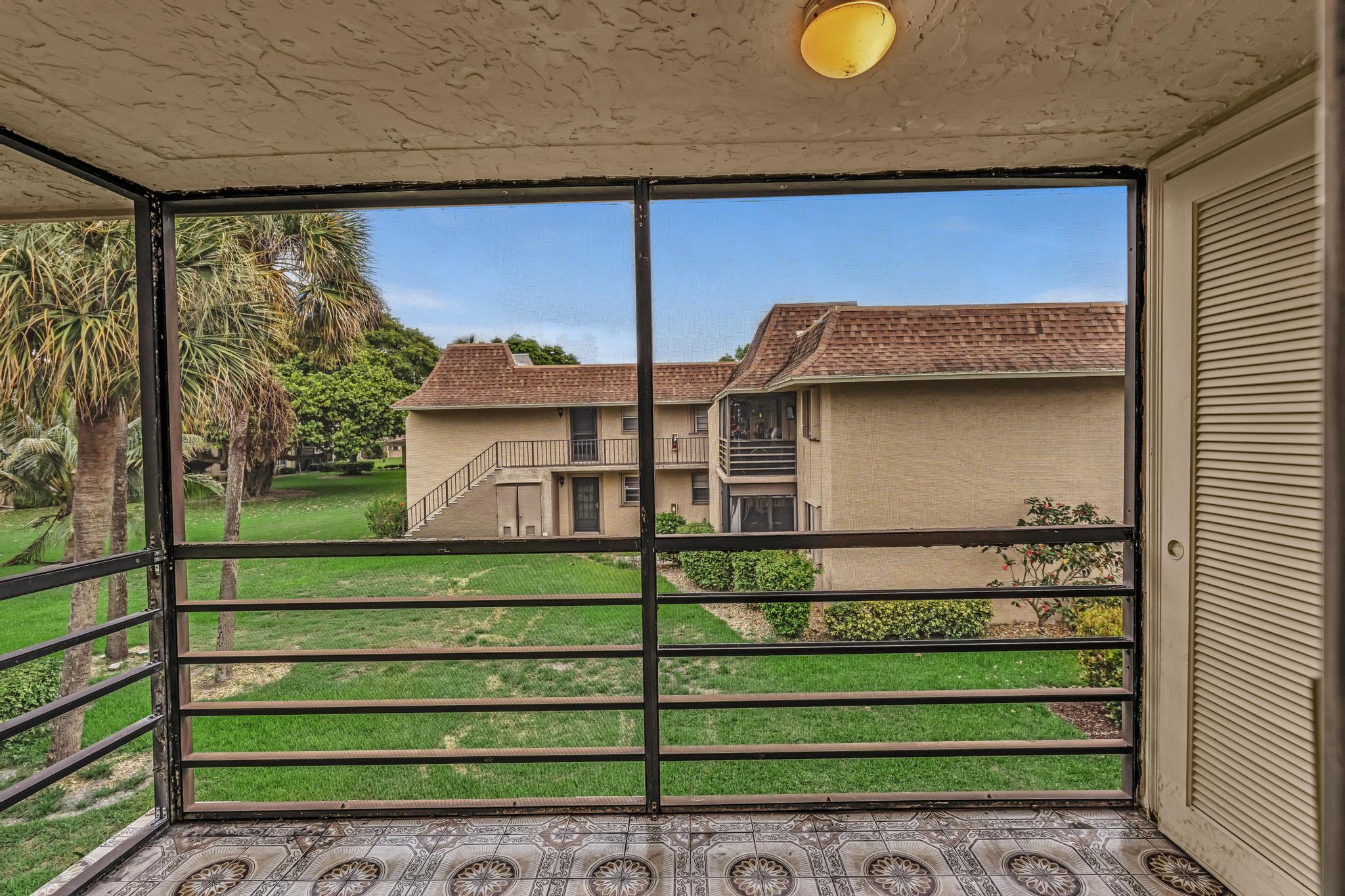 1291 Northwest 13th Street, Unit 445D Boca Raton, FL 33486 - Photo 16 of 50 a front view of a house with a garden