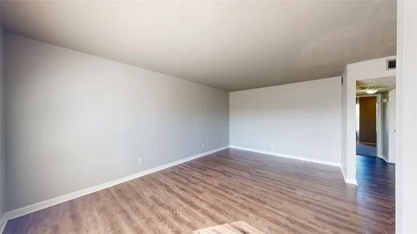 a view of an empty room and wooden floor