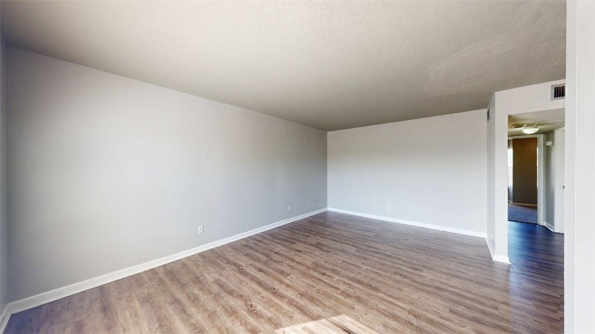 3800 East 29th Street, Unit 5 Bryan, TX 77802 - Photo 11 of 35 a view of an empty room and wooden floor