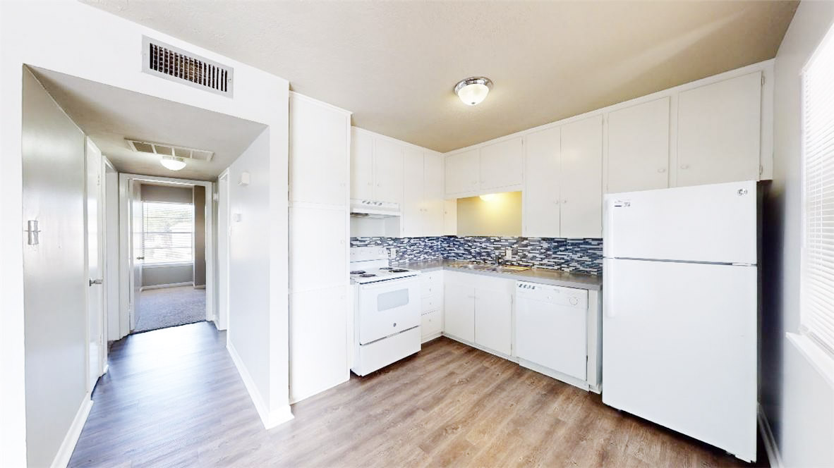 3800 East 29th Street, Unit 5 Bryan, TX 77802 - Photo 18 of 35 a kitchen with white cabinets and white appliances