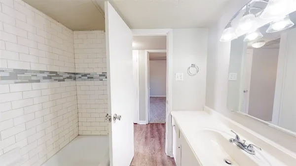a bathroom with a tub sink and shower