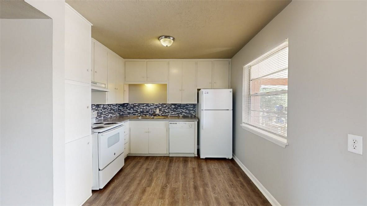 3800 East 29th Street, Unit 5 Bryan, TX 77802 - Photo 7 of 35 a kitchen with granite countertop white cabinets and white appliances