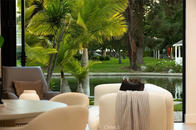 a balcony with couple of chairs and a fountain