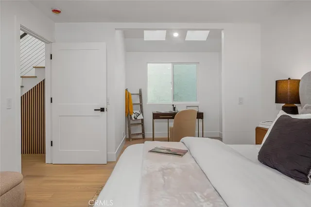 a bedroom with bed and a mirror