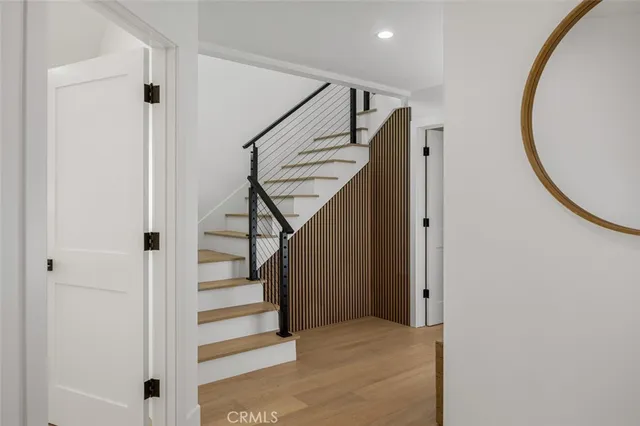 a view of a hallway with furniture and wooden floor