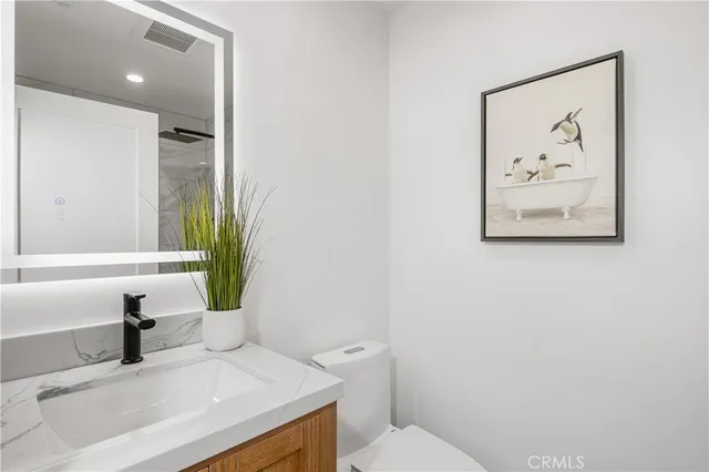 a front view of a house with a yard and potted plants