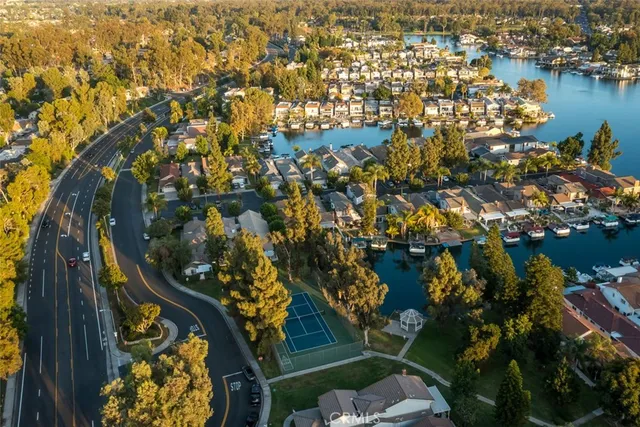 an aerial view of lake and residential houses with outdoor space