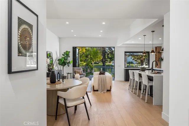 a dining room with furniture window and wooden floor