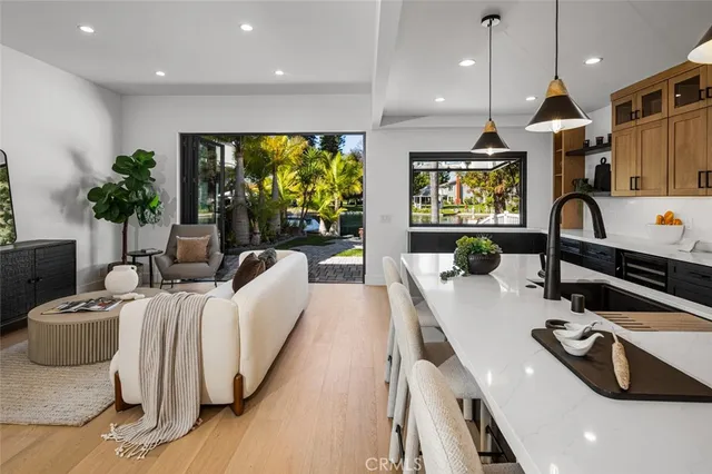 a living room with furniture a floor to ceiling window and a flat screen tv