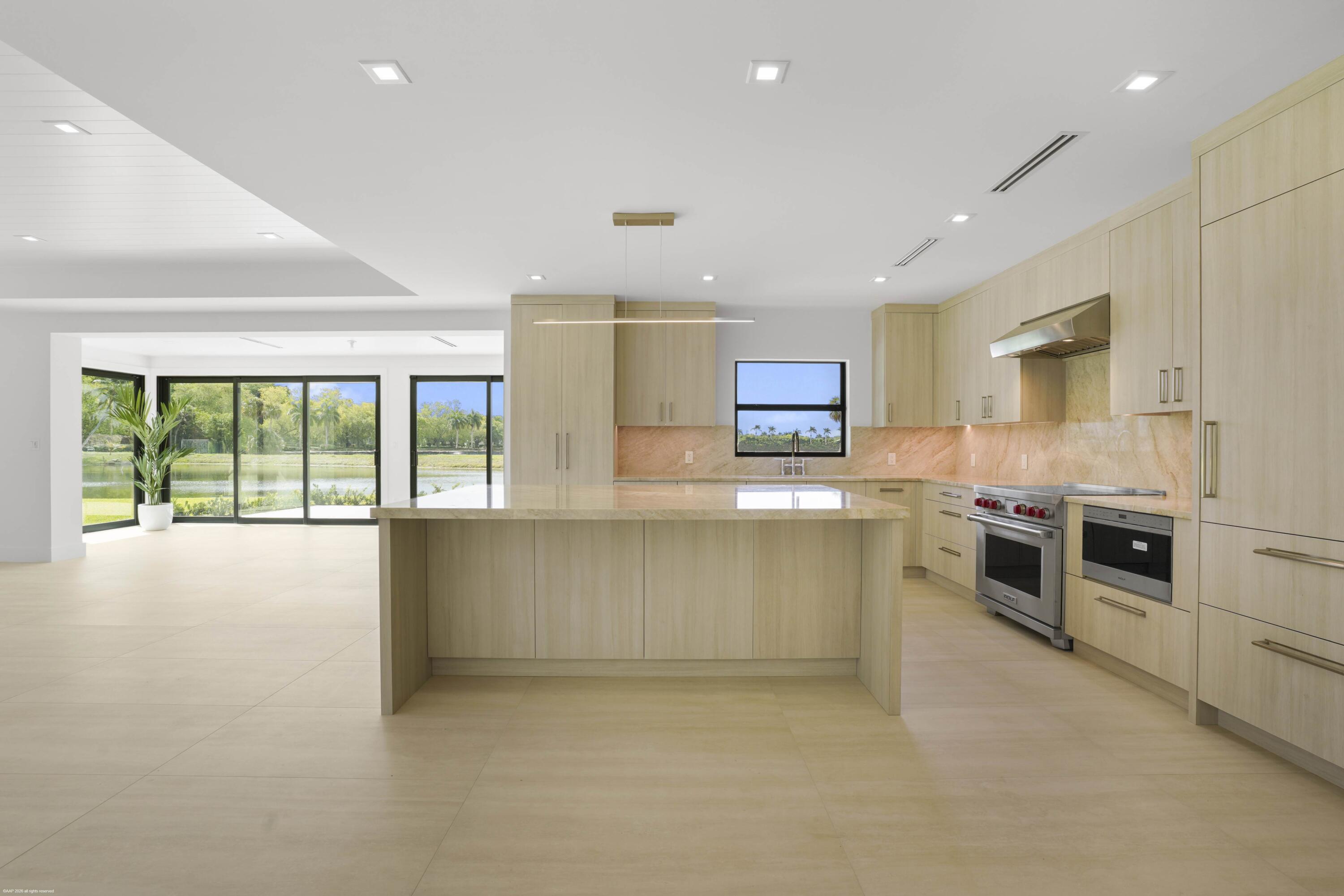 13254 Polo Club Road, Unit C101 Wellington, FL 33414 - Photo 16 of 71 a large kitchen with stainless steel appliances granite countertop a large counter top and stove top oven