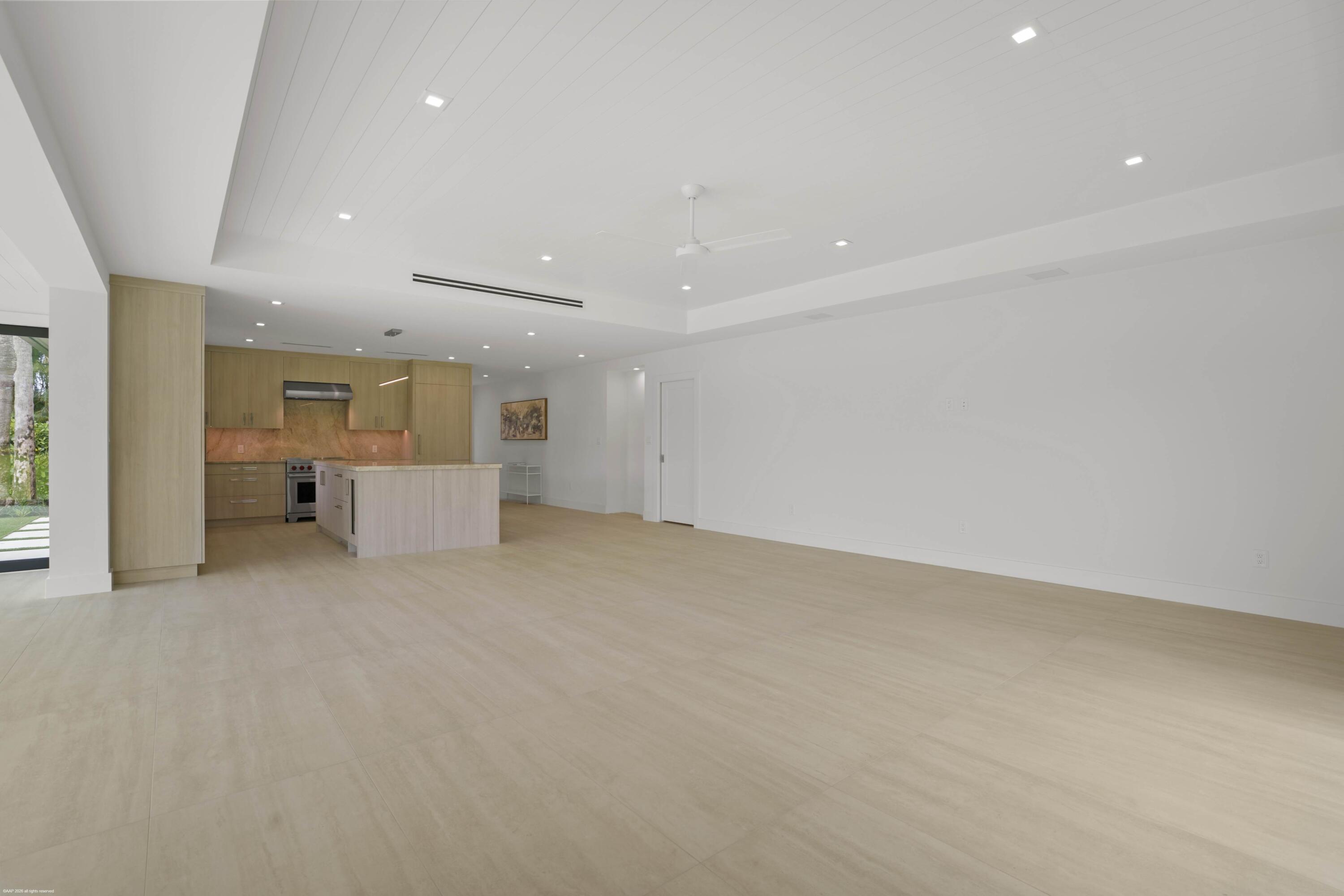 13254 Polo Club Road, Unit C101 Wellington, FL 33414 - Photo 24 of 71 an empty room with white walls and kitchen view