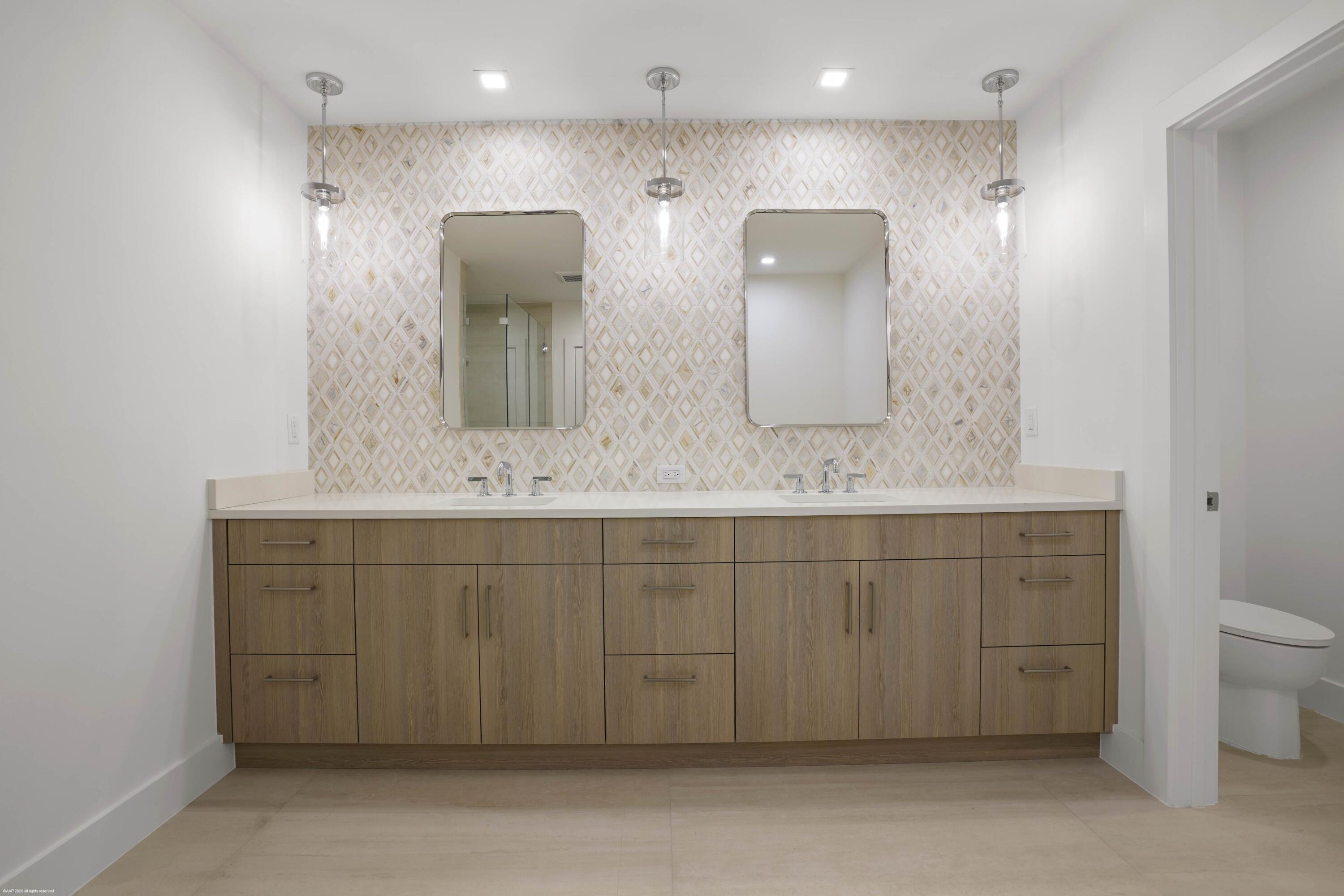 13254 Polo Club Road, Unit C101 Wellington, FL 33414 - Photo 37 of 71 a bathroom with double vanity sink and mirror