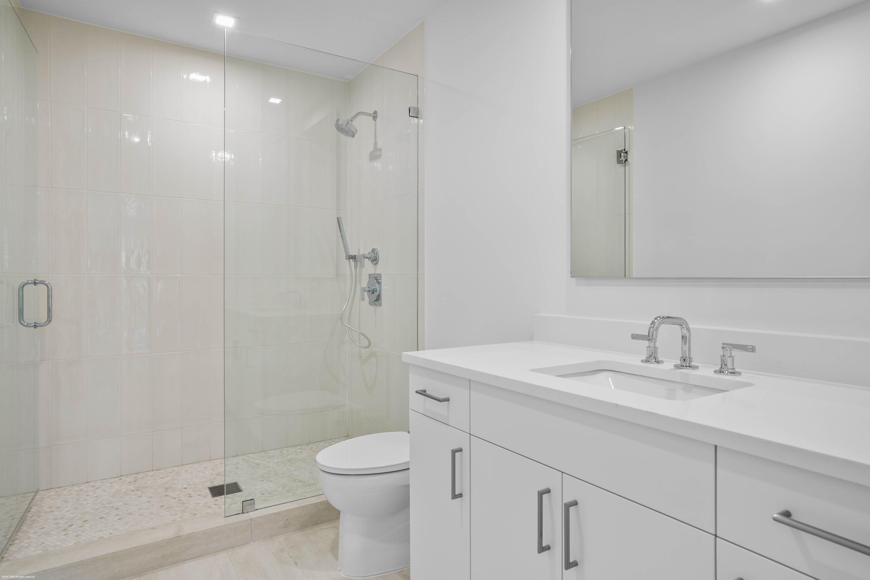 13254 Polo Club Road, Unit C101 Wellington, FL 33414 - Photo 42 of 71 a bathroom with a sink a toilet and shower
