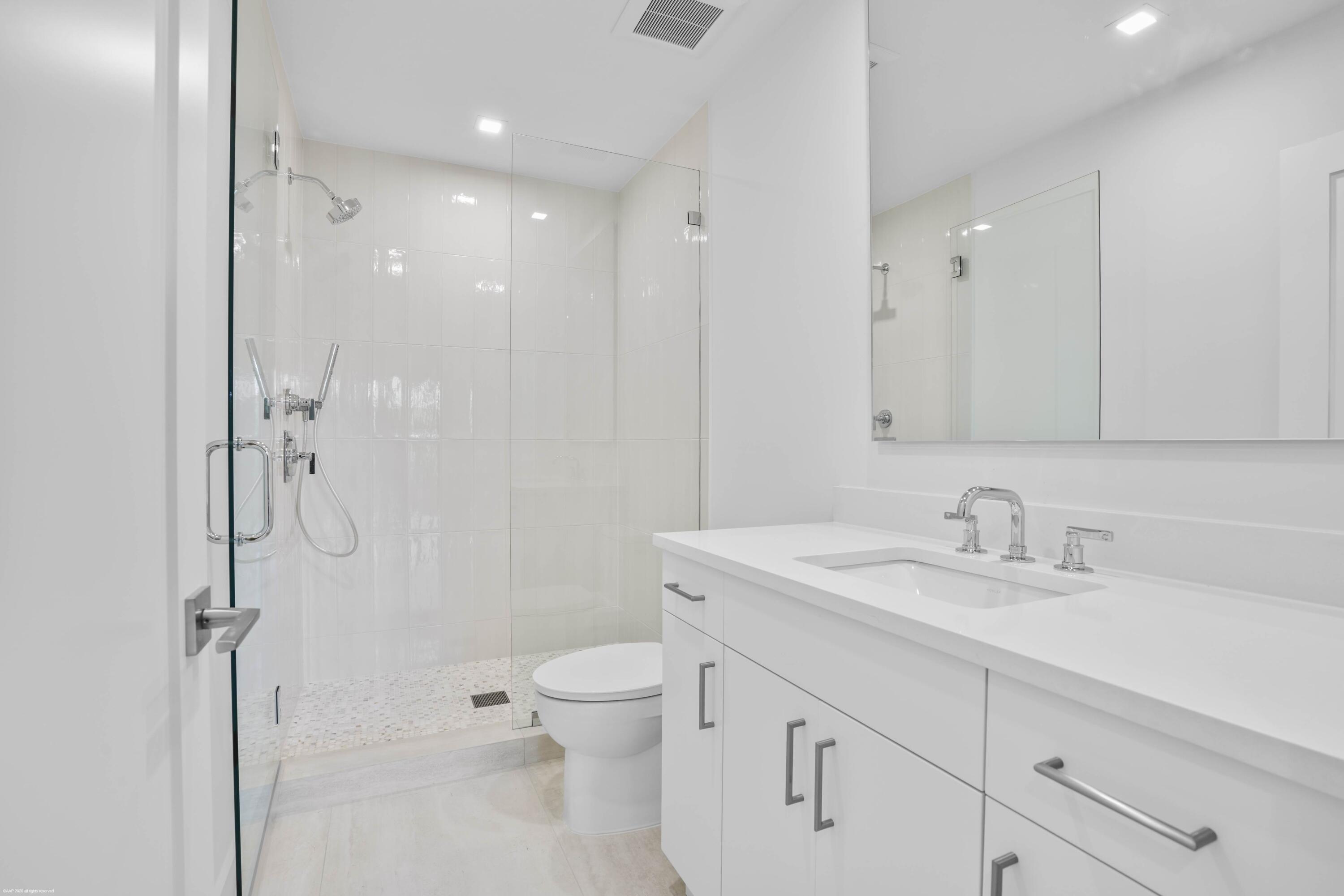 13254 Polo Club Road, Unit C101 Wellington, FL 33414 - Photo 46 of 71 a bathroom with a granite countertop sink a toilet and shower