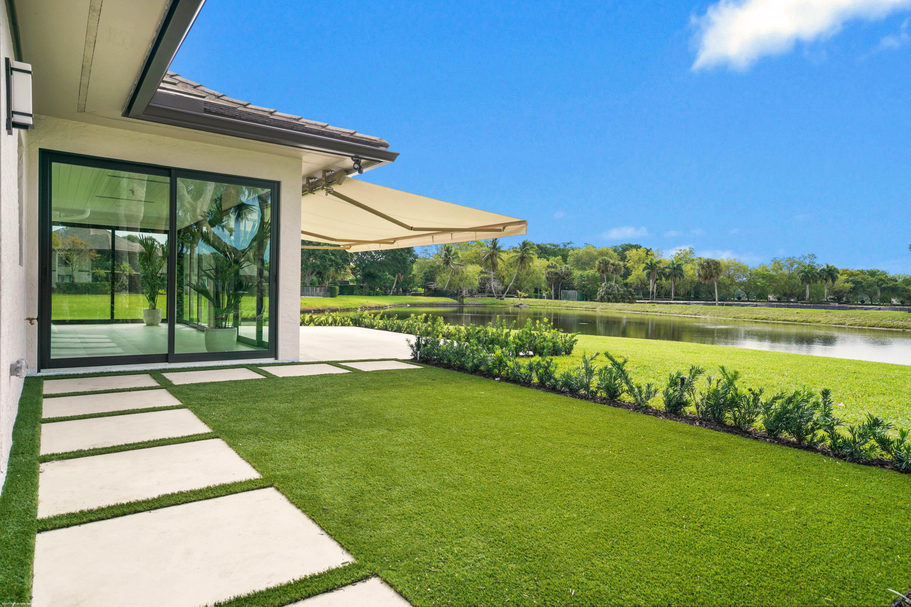13254 Polo Club Road, Unit C101 Wellington, FL 33414 - Photo 50 of 71 a view of a house with a yard and sitting area