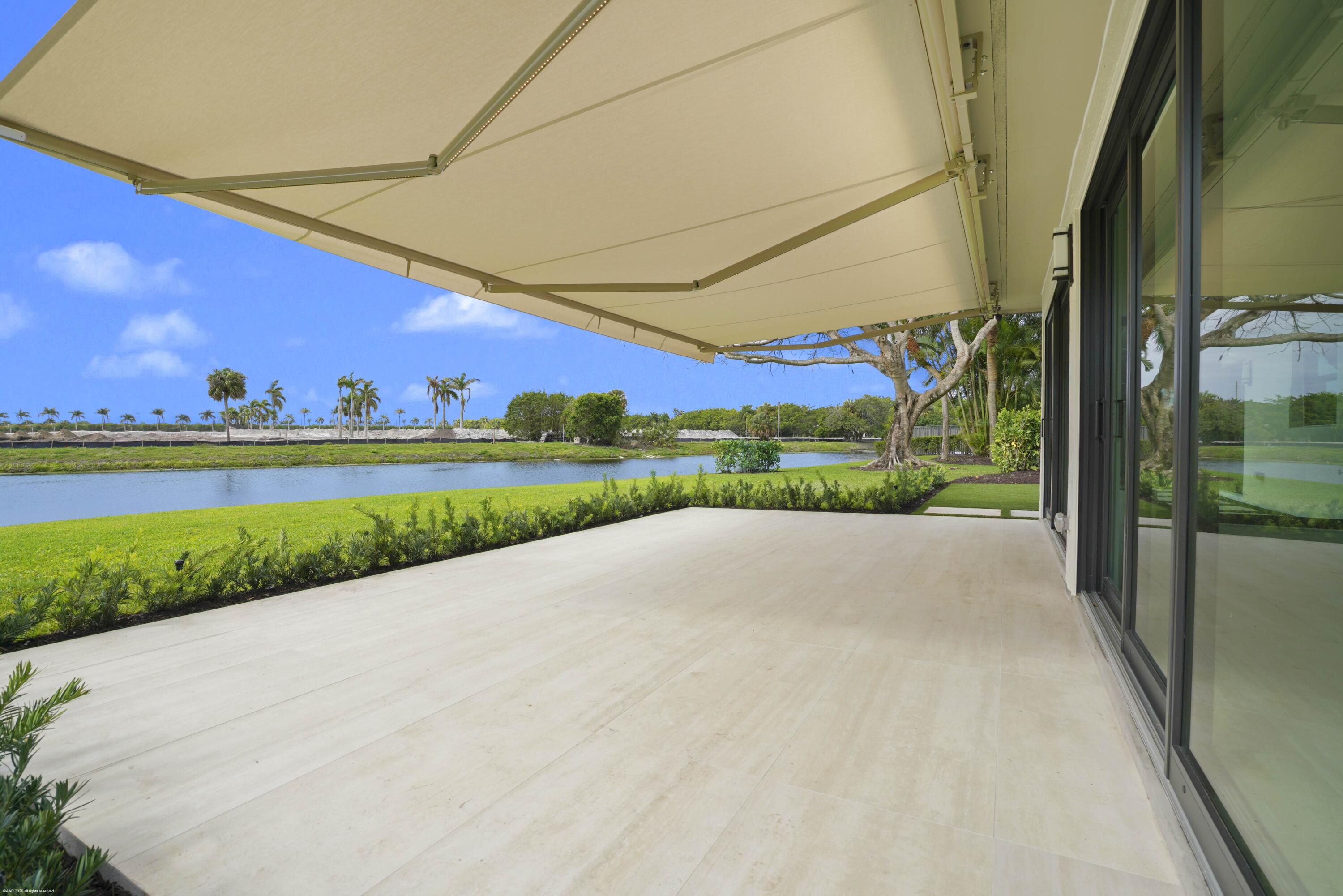 13254 Polo Club Road, Unit C101 Wellington, FL 33414 - Photo 51 of 71 a view of a big building with a big yard and large trees