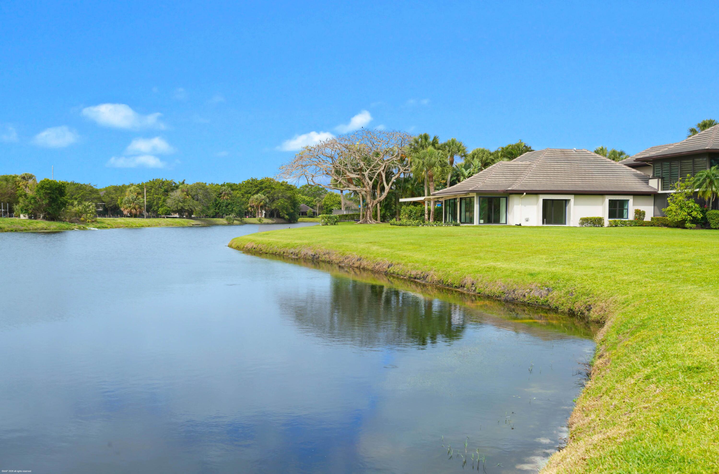 13254 Polo Club Road, Unit C101 Wellington, FL 33414 - Photo 54 of 71 a view of a house with a yard and a lake view
